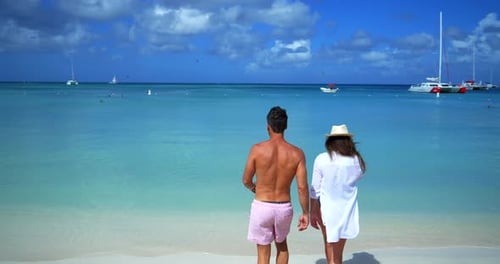 Palm Beach Noord Aruba - June 20 2016: Couple Walks Toward Ocean