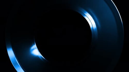 Rotating blue metallic torus on black background