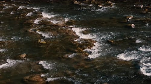 Fast flow of water on a mountain river. Beautiful mountain river.