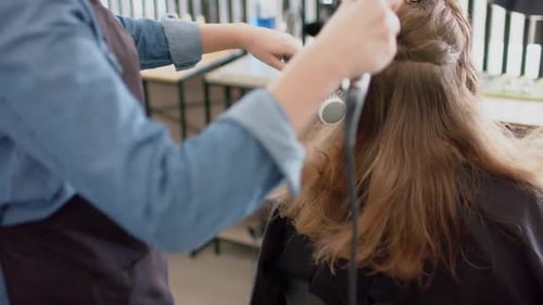 Hair Stylist Drying Hair at Salon