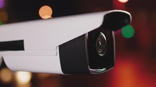 Close Up Security Video Camera Surveillance Moving to Scan the Area at Night Recording Technology