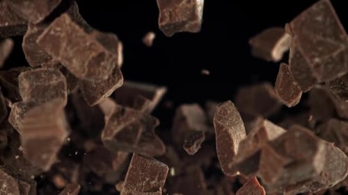 Chocolate Pieces Floating in Black Studio Environment