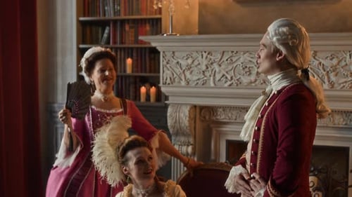 People in period clothing talking in a grand home