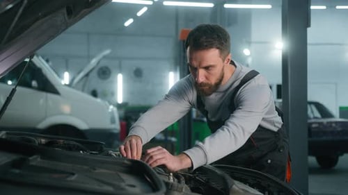 Professional Mechanic Man Caucasian Male Guy Mechanical Engineer Specialist in Uniform Fixing Car