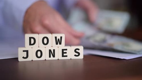 Concept of investing in the Dow Jones Stock Market. Selective focus with person counting money on th