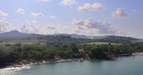 Aerial view of a magnificent landscape: an island with white beach, crystal clear sea, palm trees.