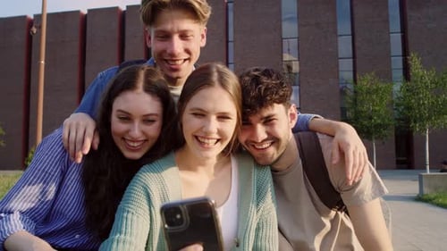 Group of caucasian students taking selfie outside the university campus. Shot with RED helium camera