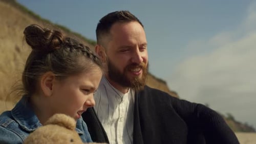 Happy family enjoying picnic on sea sand beach summer holiday vacation