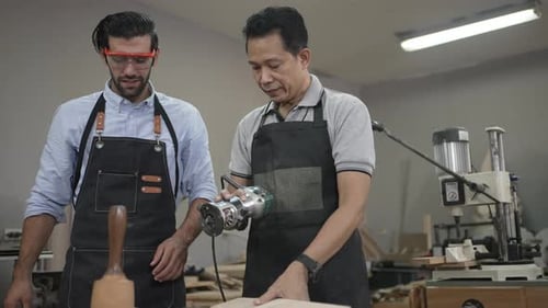 Carpenters are working together at workshop.