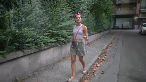 Stylish Woman Walking on Urban Street