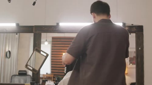 Stylish Barber Giving a Haircut in Studio