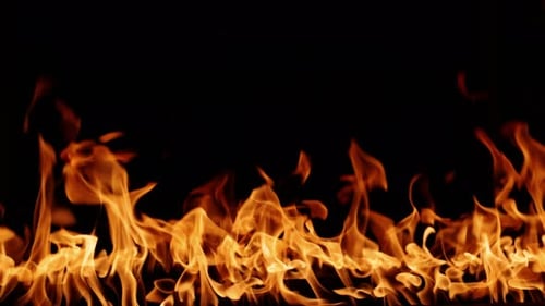 Golden Flames Burning Against Black Background