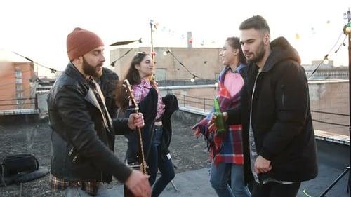 Friends Celebrate with Music on City Rooftop