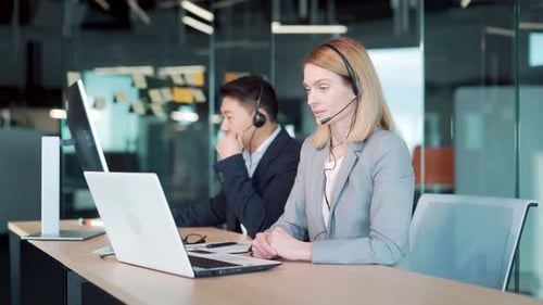 call center employee provide help to client distantly. Asian male customer services agent with heads