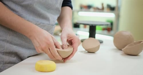Woman Forming Clay Pot Shape By Hands Closeup in Artistic Studio