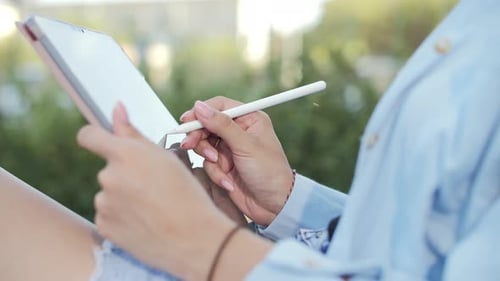 Close Up Unrecognizable Female Hands Using Stylus Writing on Digital Tablet