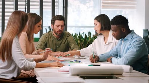 Diverse Team Collaborating on Project in Modern Office