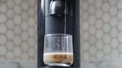Espresso Machine Dispensing Coffee into Glass