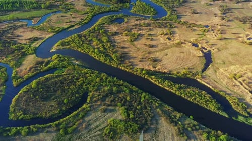 Aerial View Green Forest Woods And Curved River Landscape In Sunny Spring Day