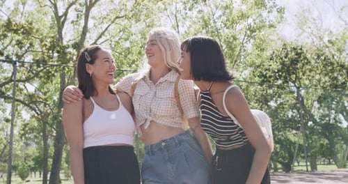 A group of young women hanging out at an urban park