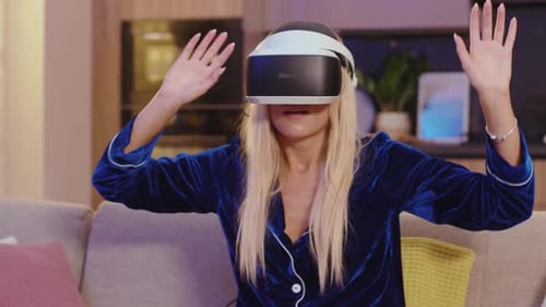 Woman in Pajamas Using Virtual Reality Headset Indoors