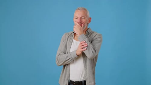 Man Looking Confused Gesturing on Blue Background