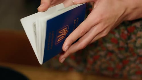 Woman Opens Passport with Visa Stamps