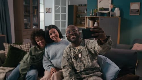 Family Taking Selfie on Sofa