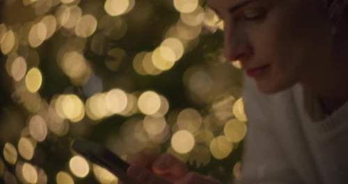 Close Up of Woman's Hands Using Smartphone at Christmas