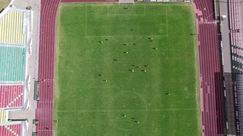 Top View of the Game of the Team in Football During Training and Empty Stands at the City Stadium