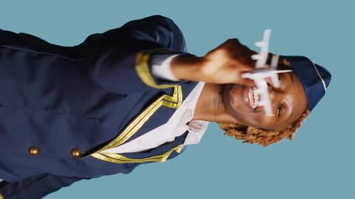 Smiling Woman in Uniform Plays With Toy Airplane