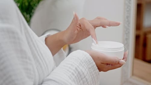 Hand Scooping Cream from Cosmetic Jar