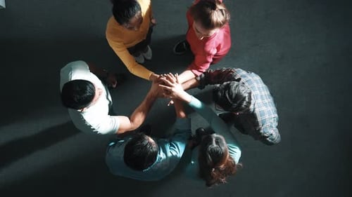 Top view of smart team working together and putting hands together. Symposium.