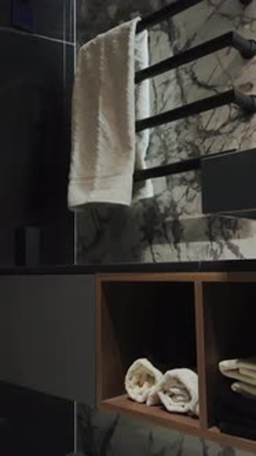 Modern Bathroom Interior with Black Marble and Towels