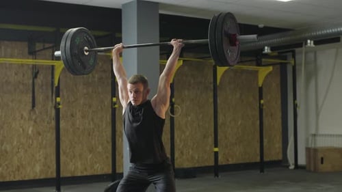 Strength training session in gym with athlete lifting barbell for competition preparation