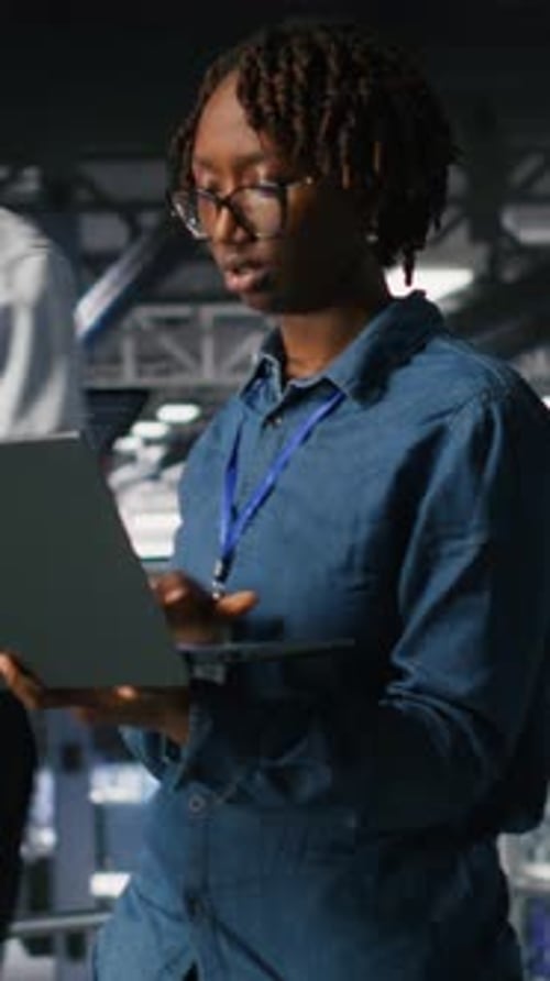 Vertical Video Data Center Engineer Walking on Industrial Platform Running Diagnostics