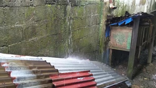 Heavy tropical rain in the back garden of a Bislig home.