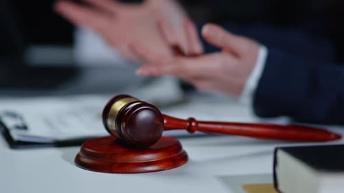 Wooden Gavel on Table in Courtroom Setting