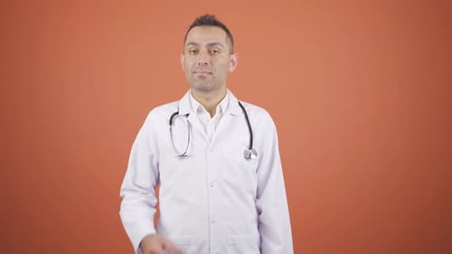 Man in Lab Coat Gesturing in Studio