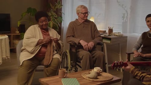 Diverse Seniors Sharing Heartfelt Evening Together in Cozy Nursing Home