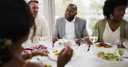 Diverse Friends Enjoying a Cheerful Indoor Meal