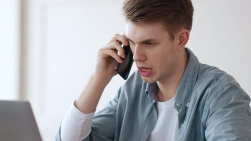 Serious Man Entrepreneur Communicating with Partners By Phone
