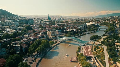 Aerial View of Tbilisi Beautiful Architecture and the Kura River Under Sunny Skies Daylight Drone
