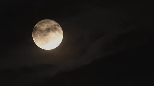 Beautiful Full Moon Rise Through Drifting Dark Clouds Captured in Cinematic Time Lapse