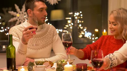 Friends Drinking Wine Together at Holiday Dinner Party
