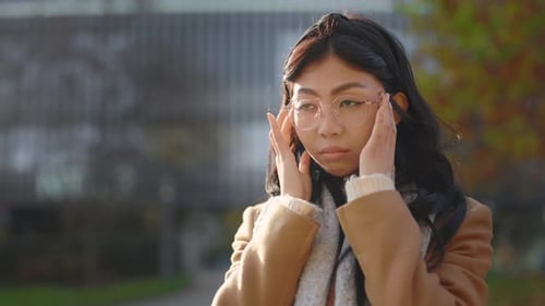 Young Asian Woman Suffering For Headache at Street Beautiful Girl Feeling Stress And Strong Head