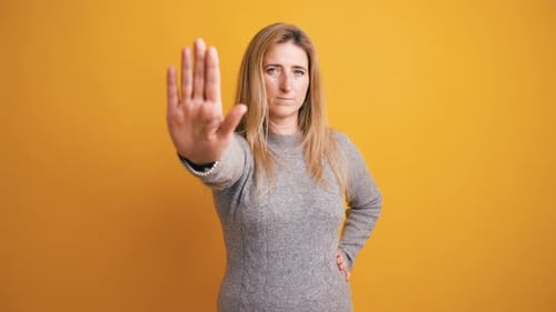 Woman Showing a Stop Gesture with Her Hand