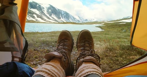 Feet, camping tent and relaxing on holiday, travel and mountain view on morning in nature