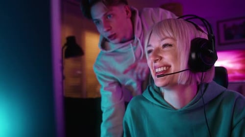 Young Adults Playing Video Games Together at Night