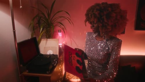 70s Female Disco Star Playing Vinyl Record in Record Player